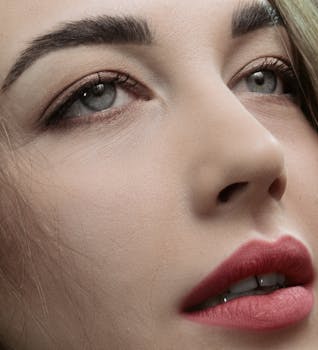 Detailed close-up of a woman's face highlighting natural makeup and features.