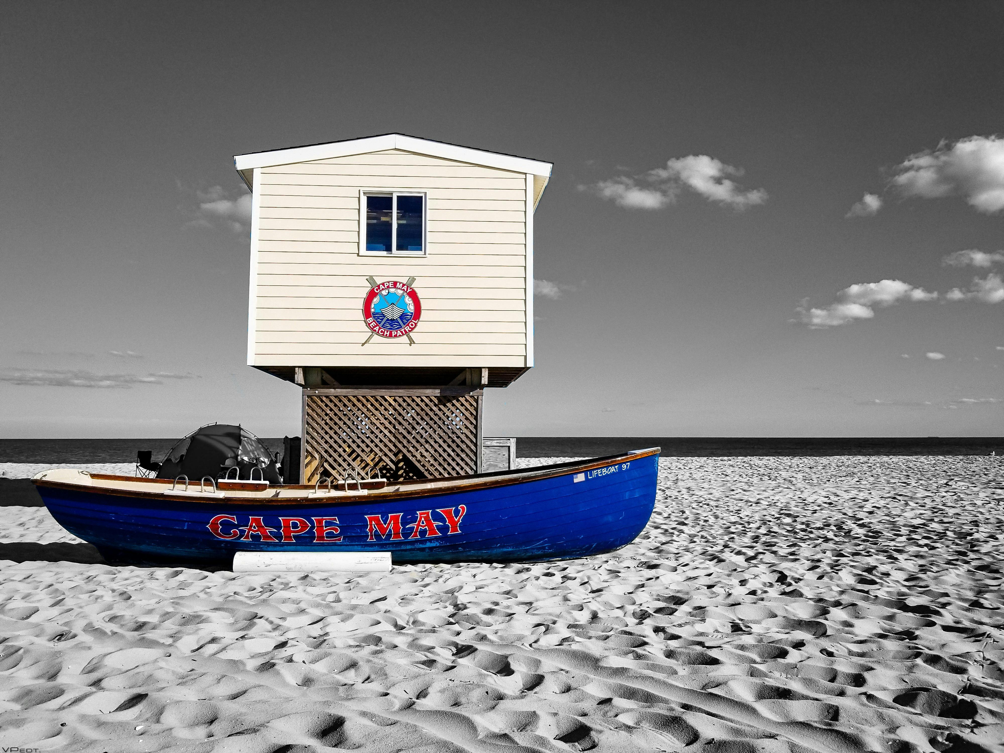 Passionate couple in deep embrace on bed, soft lighting and rain glow, moment of intense erotic connection
