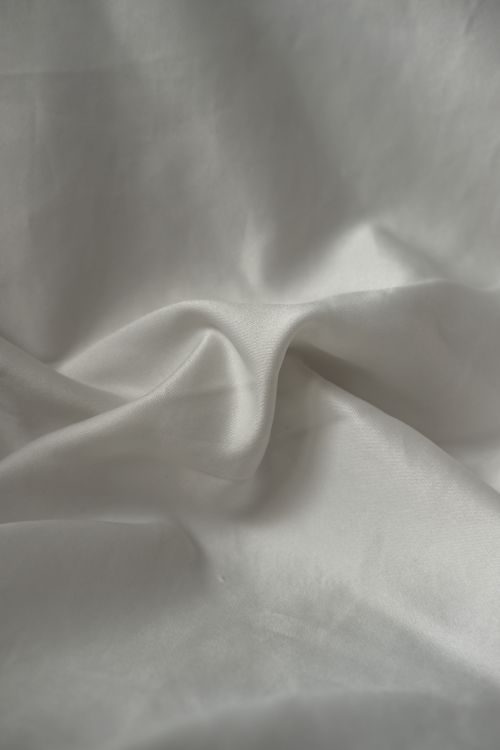 Free Artistic close-up shot of white fabric folds creating a smooth texture. Stock Photo