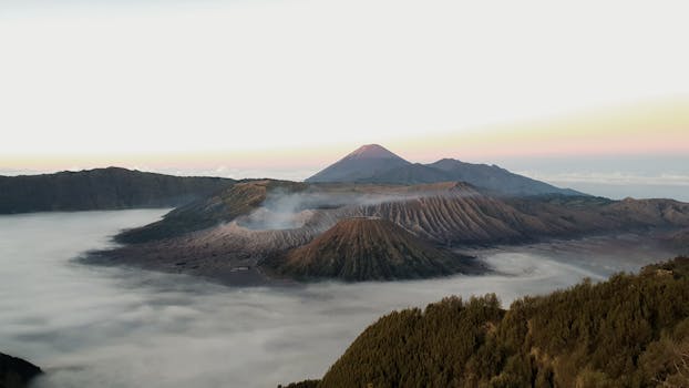 A breathtaking sunrise view over Mount Bromo and its misty surroundings in East Java, Indonesia.