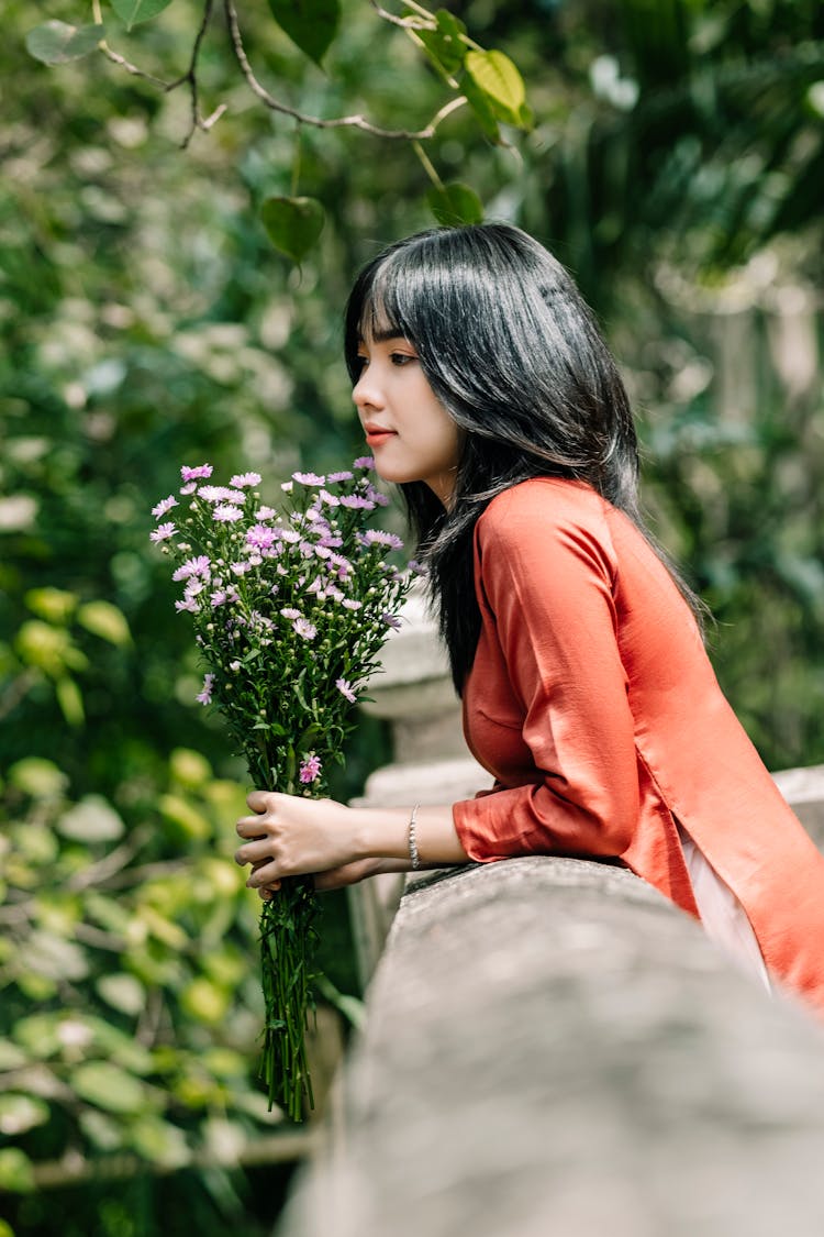 Woman With Flowers In Park