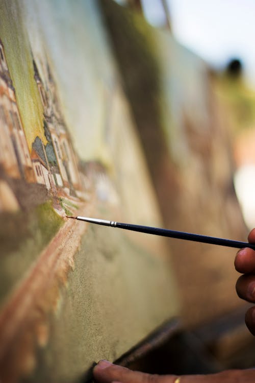 Closeup Photo of Person Holding Paintbrush