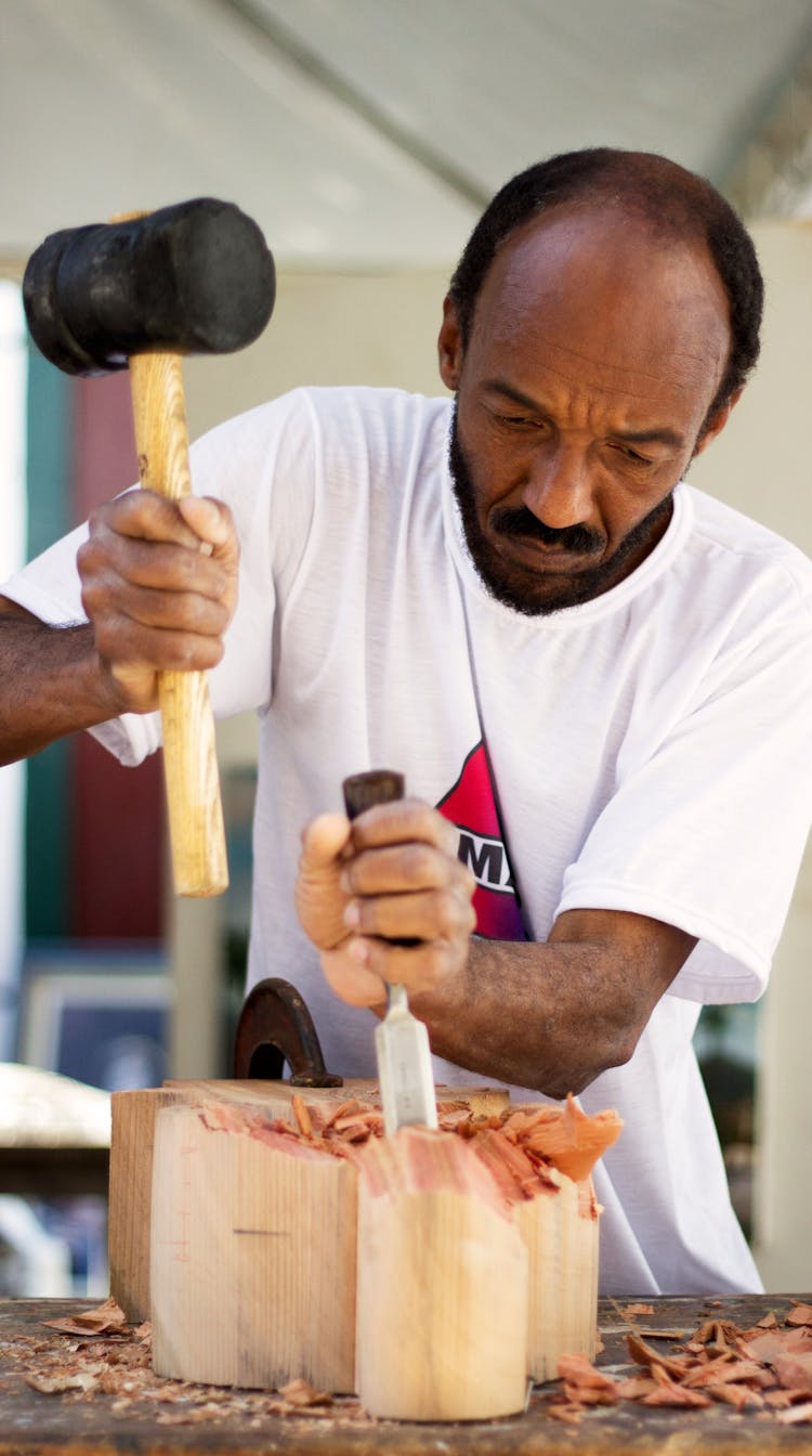 Man Holding Chisel And Mallet