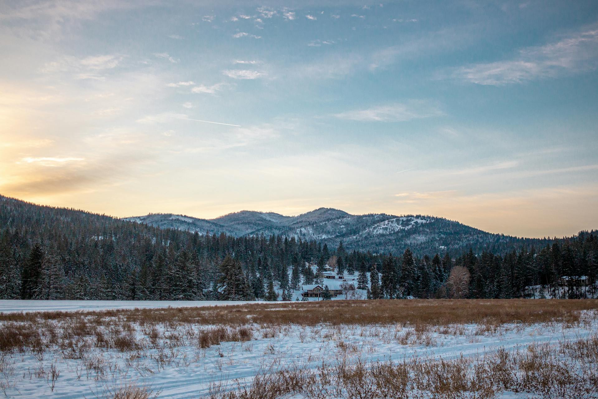 Breathtaking winter landscape of snow-covered fields and mountains in Post Falls, Idaho.