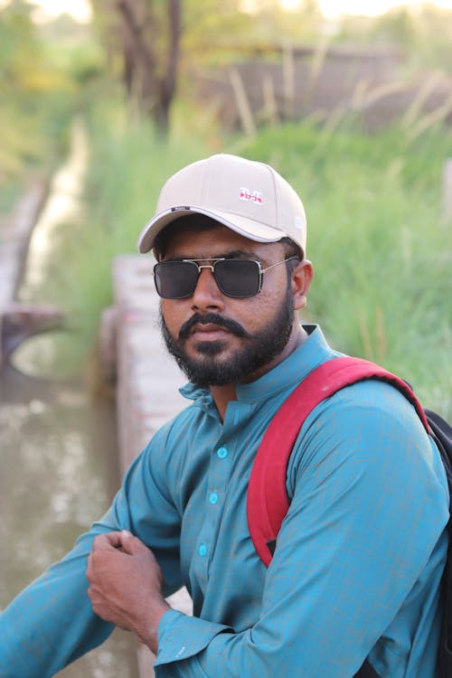 Man in Blue Dress Shirt Wearing Sunglasses