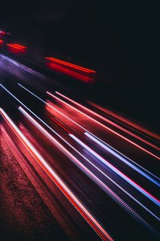 A captivating long exposure shot of colorful light trails on a Dortmund road, showcasing urban life after dark.