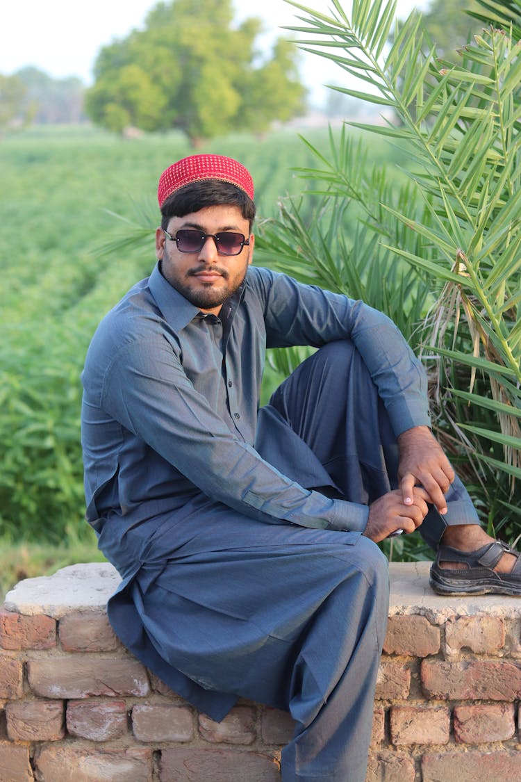 Man Wearing A Red Sindhi Cap