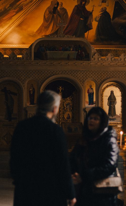 Free Two individuals inside an ornate Orthodox church in Baku, Azerbaijan. Stock Photo