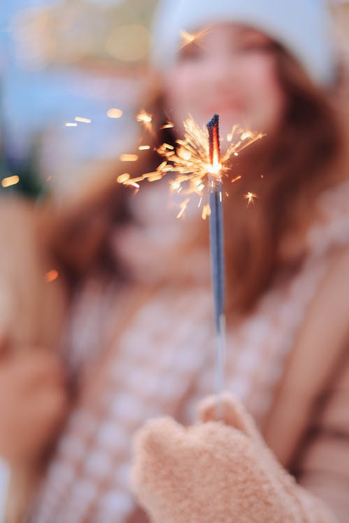 A Woman Holding a Burning Sparkler