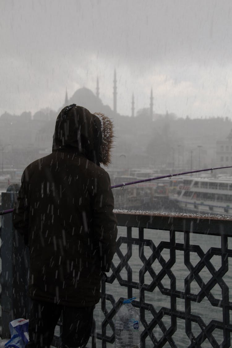 Fisherman On Galata Bridge In Downpour