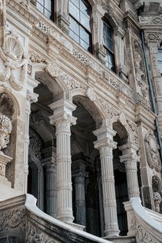 Intricate facade of a historical palace showcasing carved columns and architectural details.