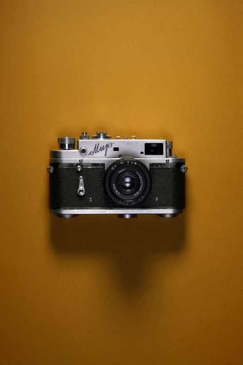 Free Classic vintage USSR camera on brown backdrop, showcasing timeless design. Stock Photo
