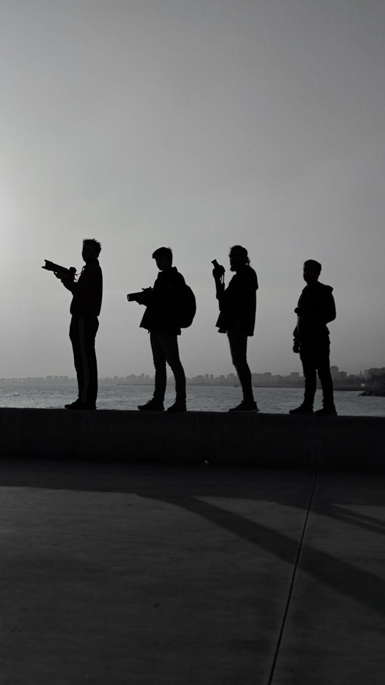 Silhouette Of People With Cameras