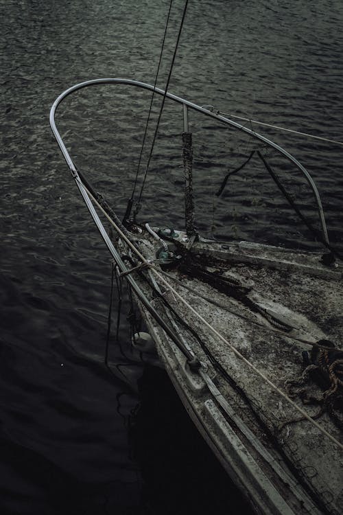 Grayscale Photography of Shipwreck Floating on the Sea