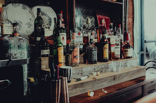 Bottles with Alcohol on a Shelf in a Bar 