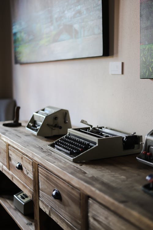 Gray Typewriter on Wooden Cabinet