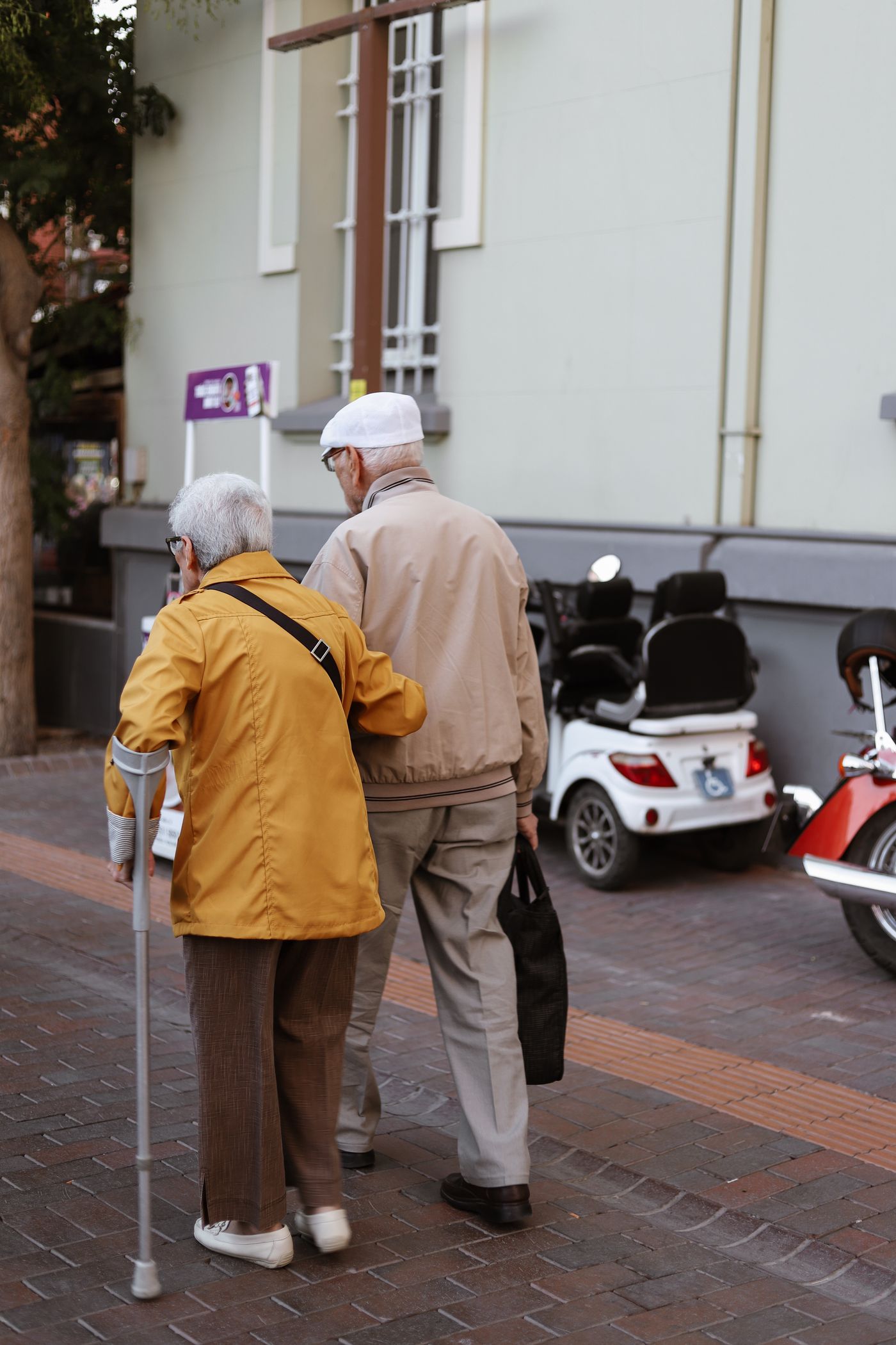 An older couple walking outdoors together
