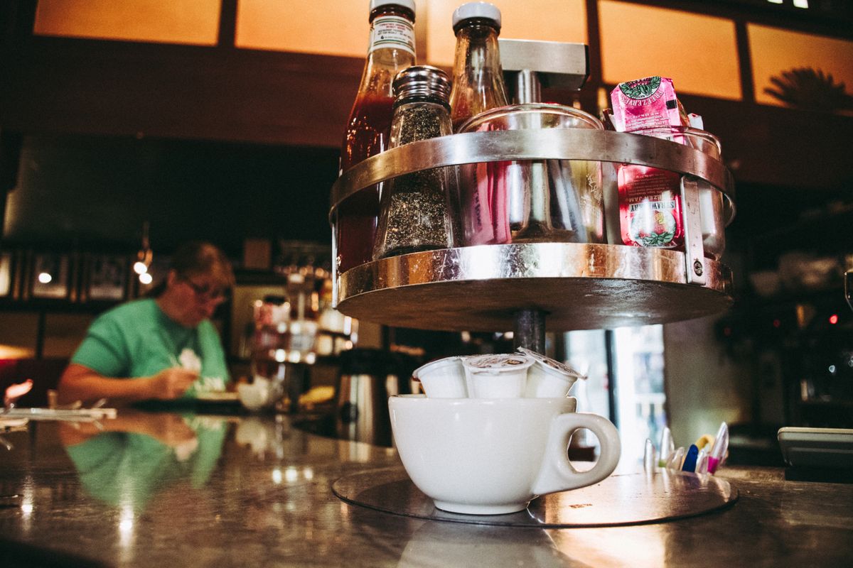 Classic diner countertop setting with vintage condiments and warm hospitality