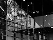 Grayscale Photo of a Glass Building