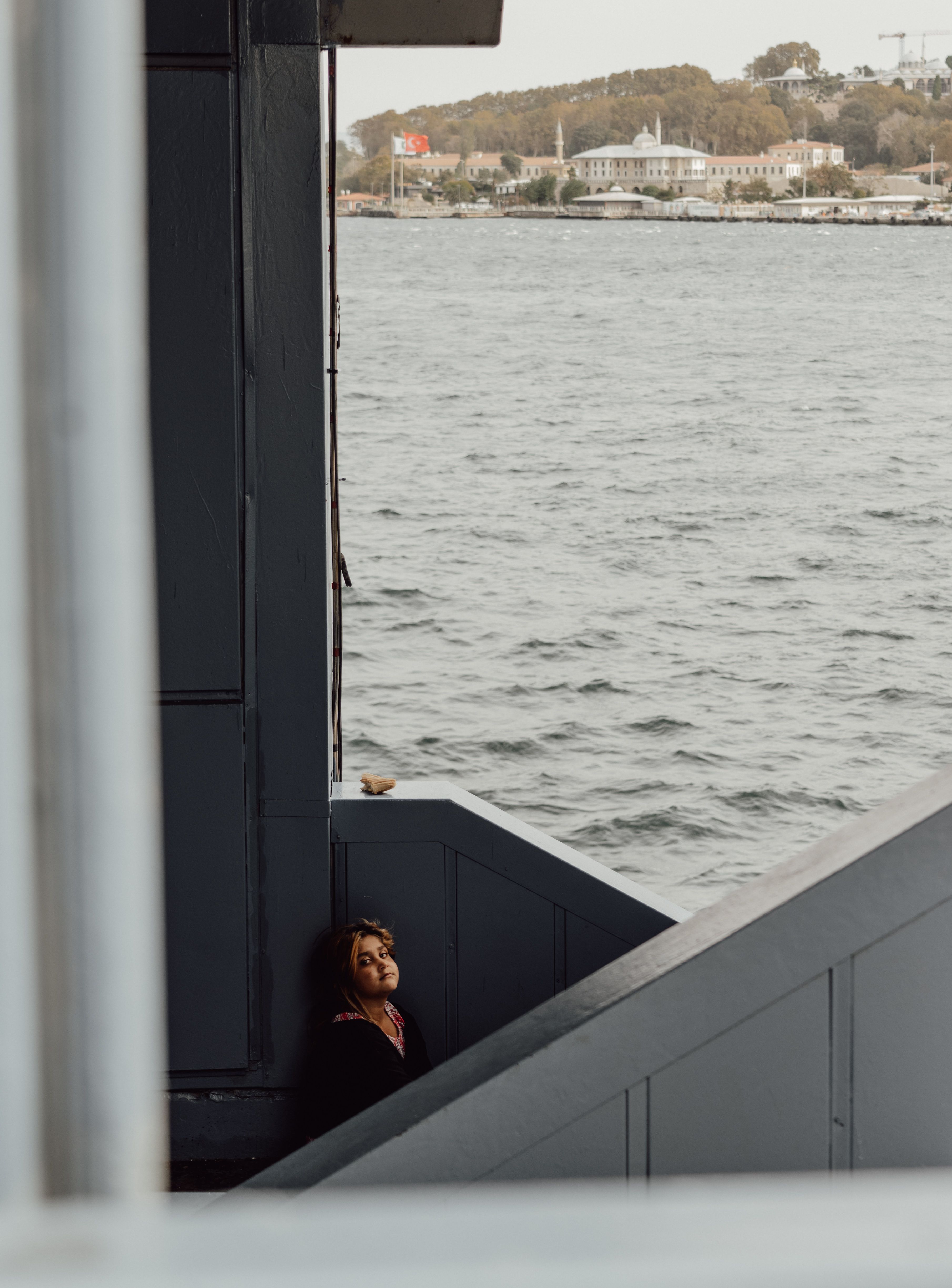 Woman Standing by Wall on Sea Coast in Turkey · Free Stock Photo