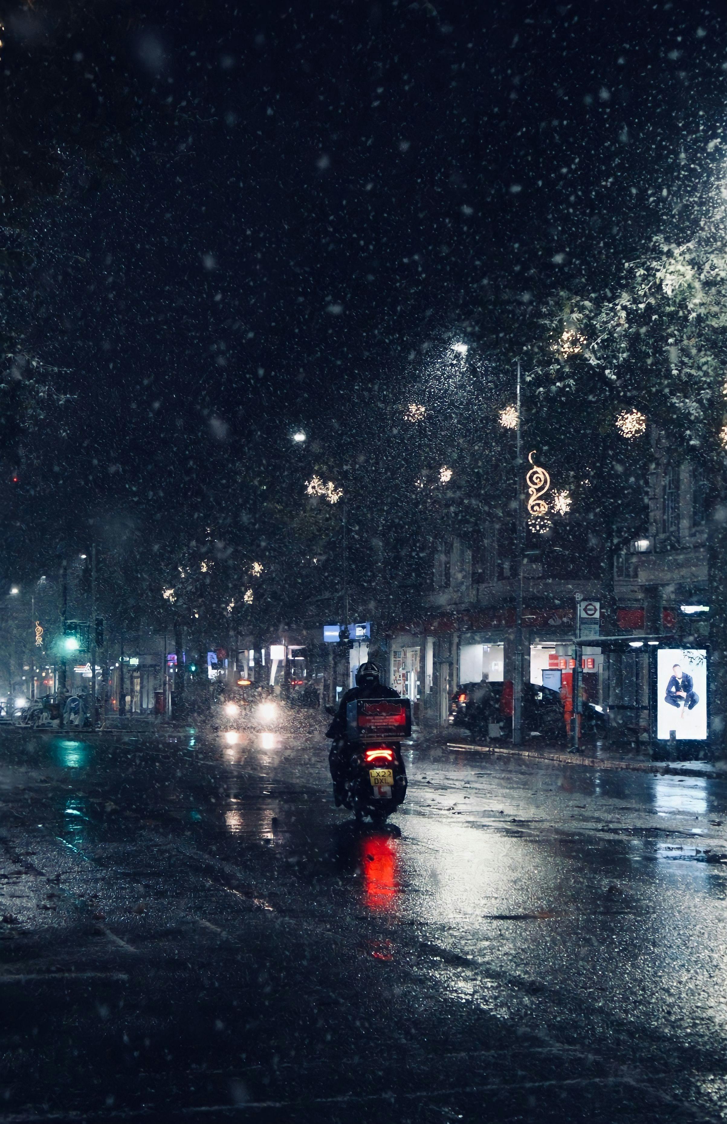 Motorbike on a snowy London street at night. Captures winter city vibe.