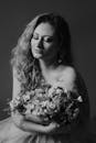 Black and White Shot of a Woman Holding Bouquet