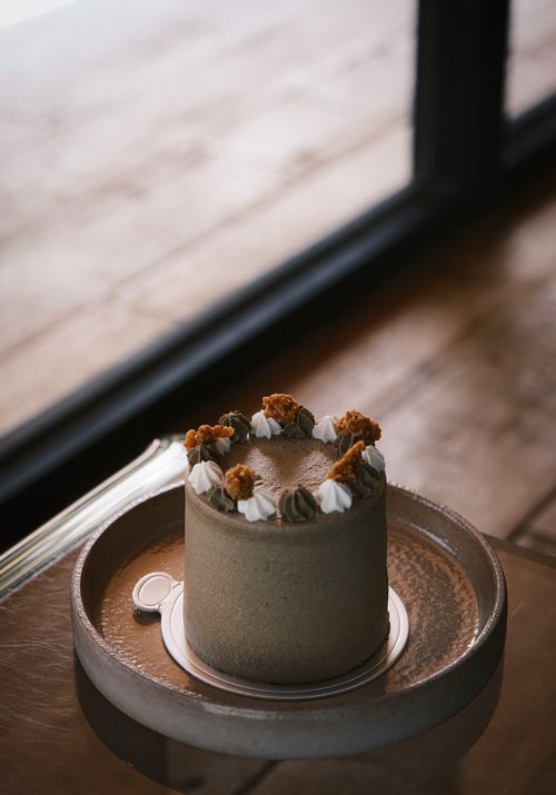 Free Delicious chocolate cake adorned with nuts and icing, perfect for dessert. Stock Photo