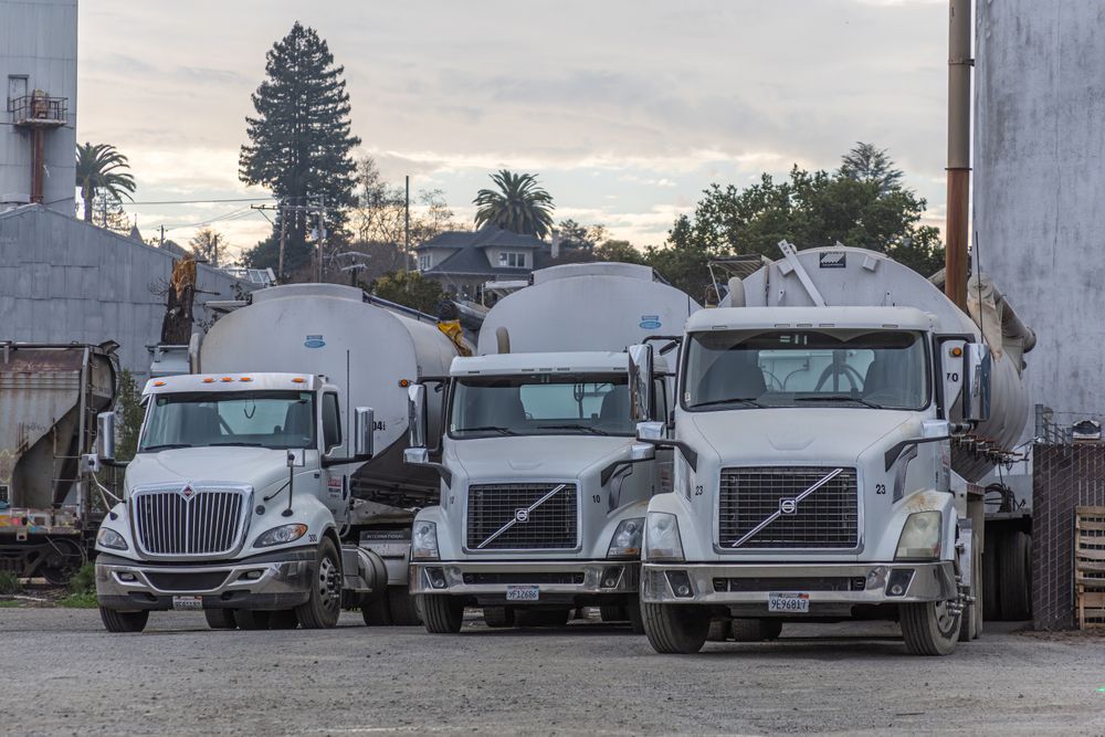 Row of white commercial trucks ready for transport services in Dubai