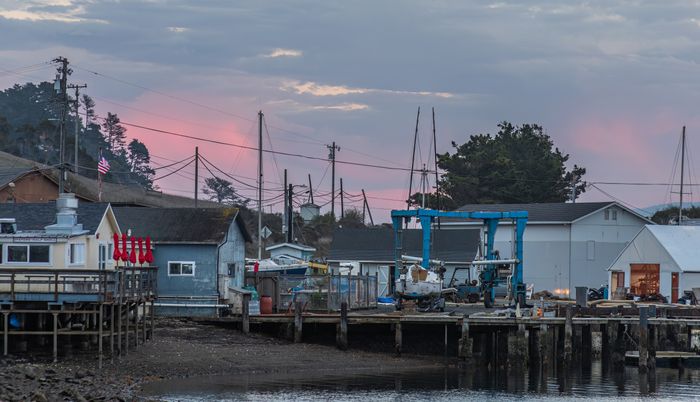 A coastal village and its docks at dusk — photo by Robert So on Pexels