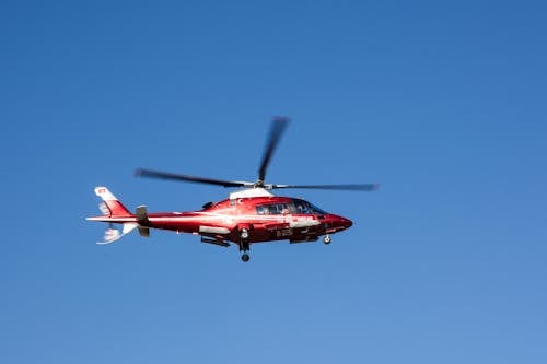 Kostenlos Fliegender Roter Und Weißer Hubschrauber Stock-Foto