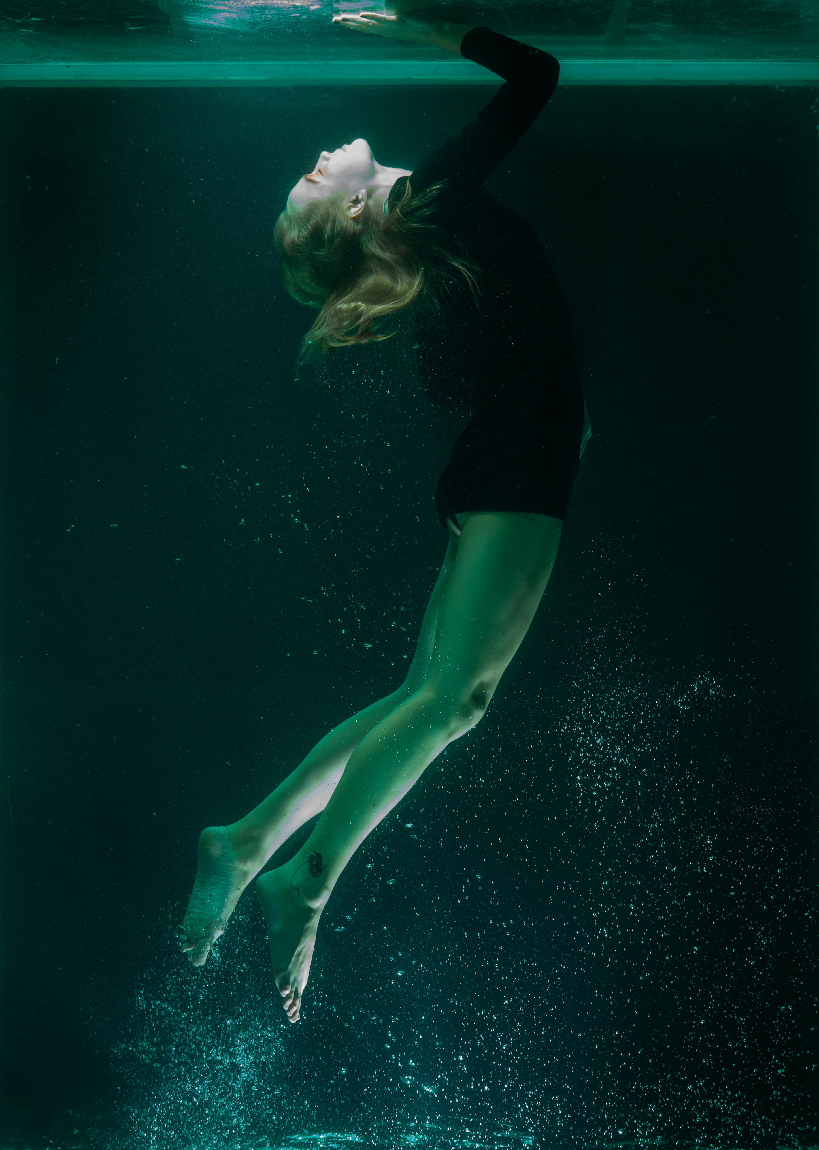 photo of woman swimming underwater