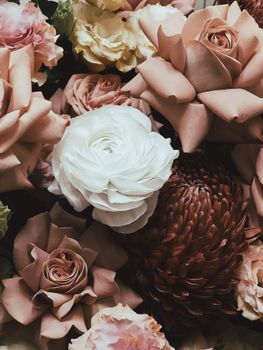 A stunning arrangement of roses and chrysanthemum showcasing soft and muted colors.