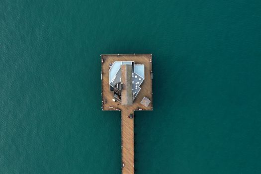 Stunning aerial shot of the Oceanside Pier showing vibrant teal ocean water.