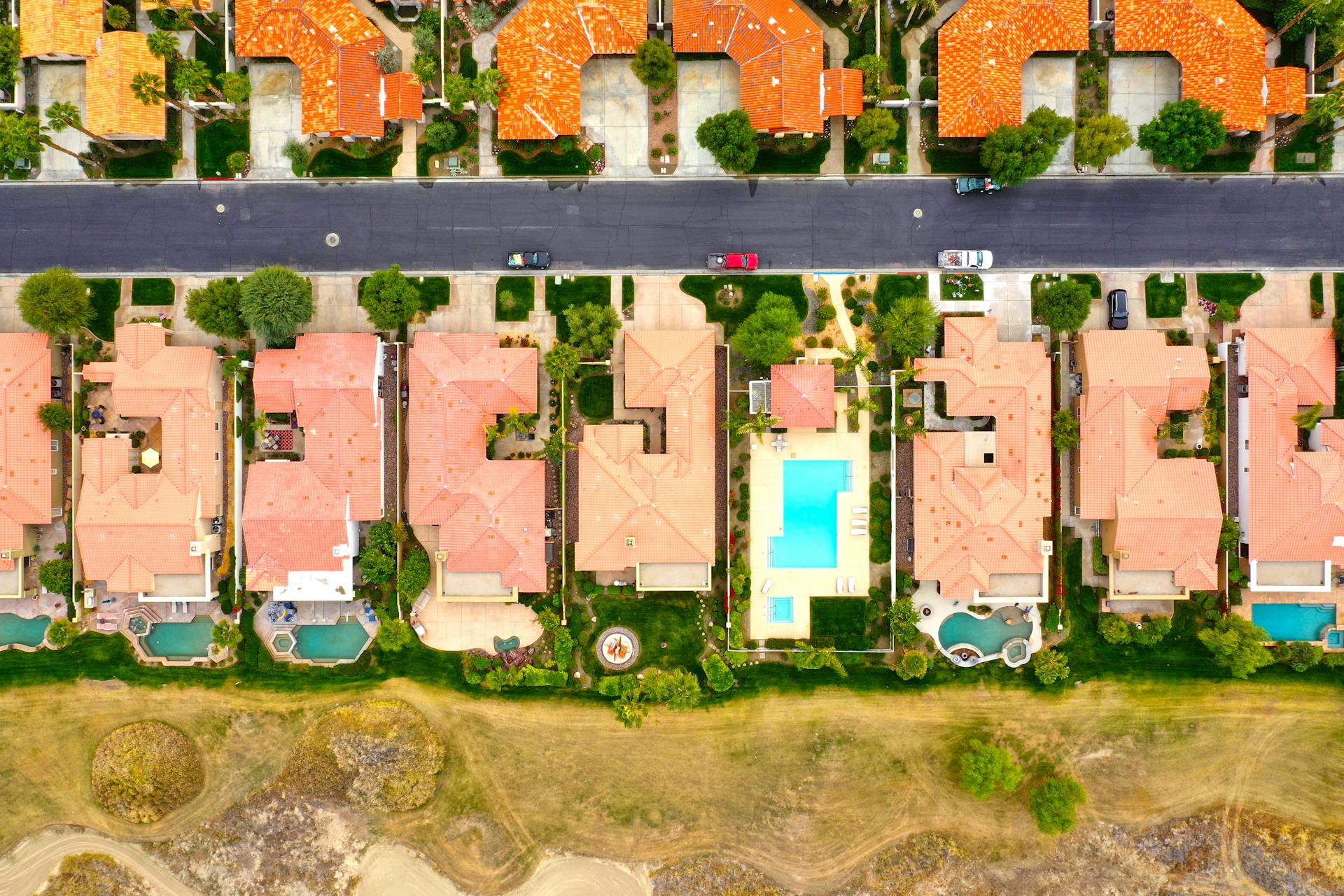 Stunning aerial view of resort-style homes with swimming pools in La Quinta, California.