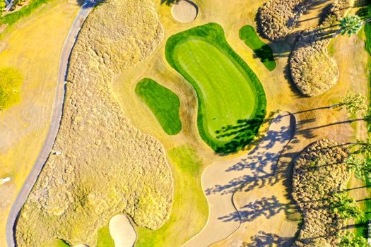 Bright aerial shot of a lush golf course in La Quinta, California, showcasing vibrant green and sandy textures.