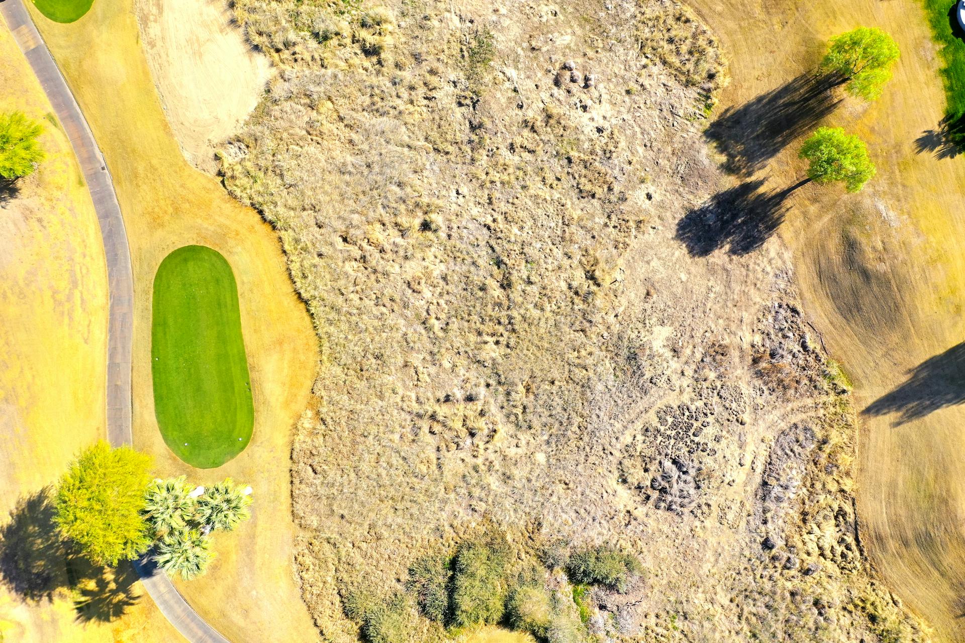 Stunning aerial shot of a golf course landscape in La Quinta, California, highlighting greens and natural textures.