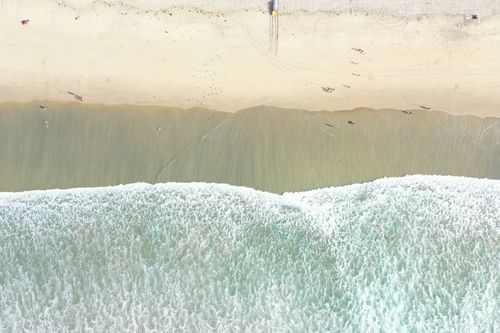 Free Stunning aerial view of San Diego's beach with gentle waves and sandy shoreline. Stock Photo