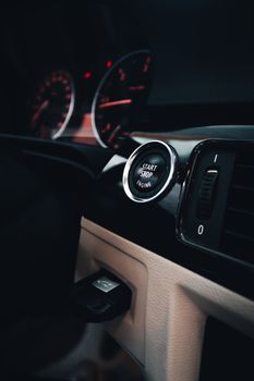 Close-up of a modern car dashboard in İzmir, featuring a start button and sleek design.
