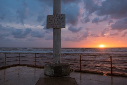 A Pillar with a Board on the Shore