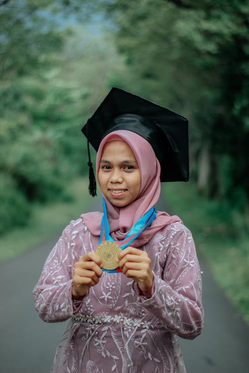 Portrait of Woman Wearing Mortarboard and Medal
