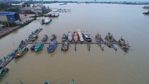 An Aerial Shot of a River with Docked Boats