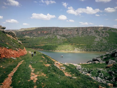 Scenic View of River between Green Hills