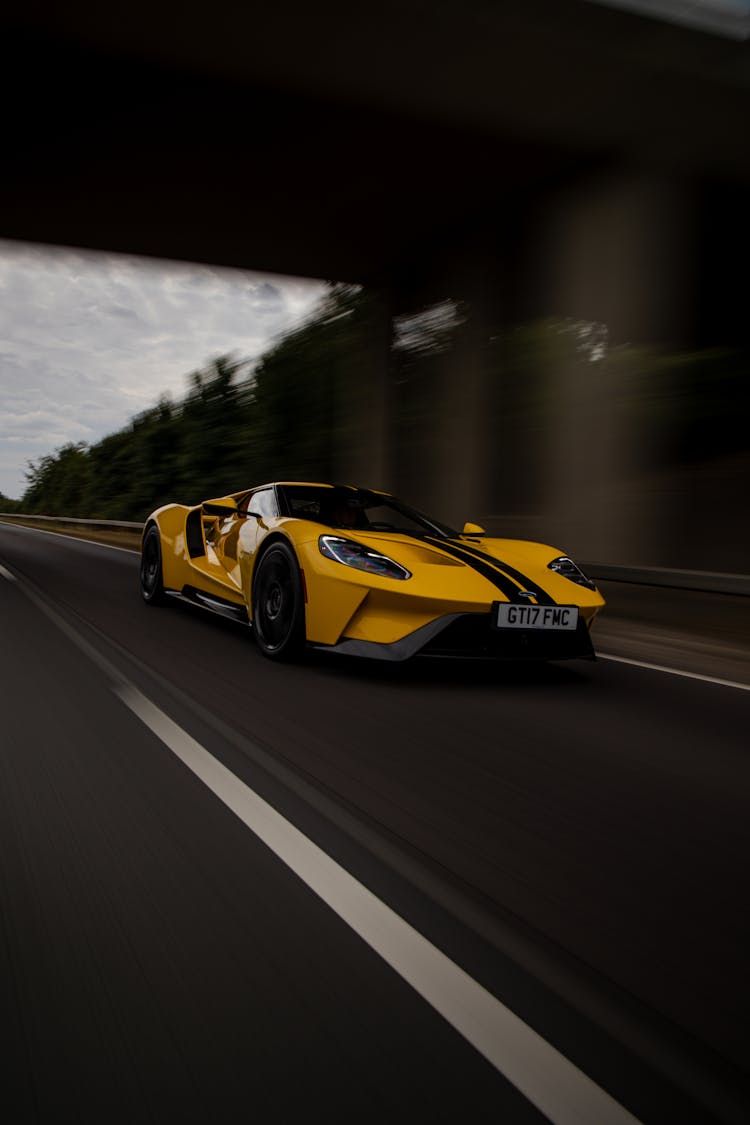 A Yellow Ford GT Sports Car On Highway Road