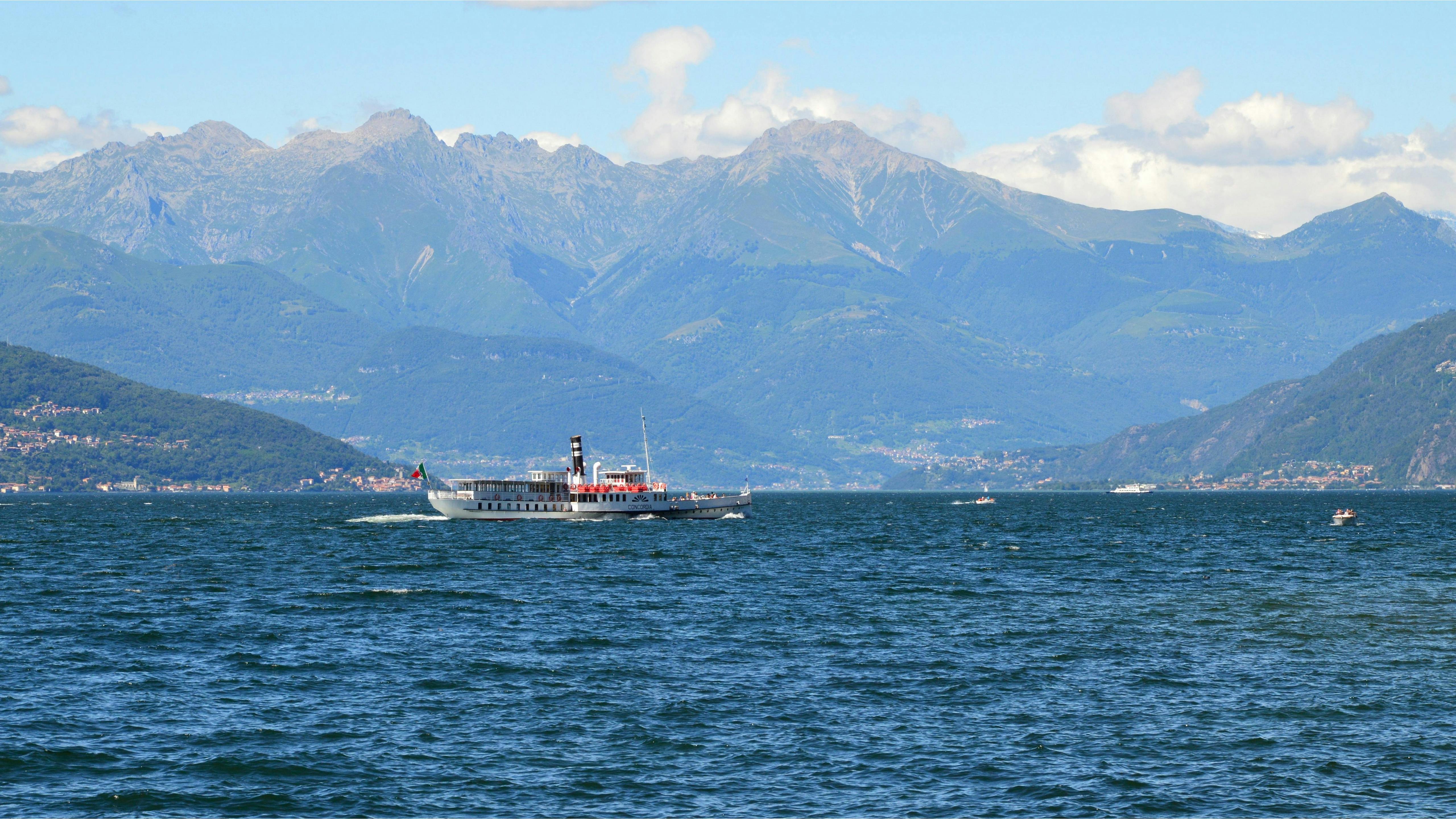 White Ship Traveling Through Vast Body Of Water With White Birds Flying 