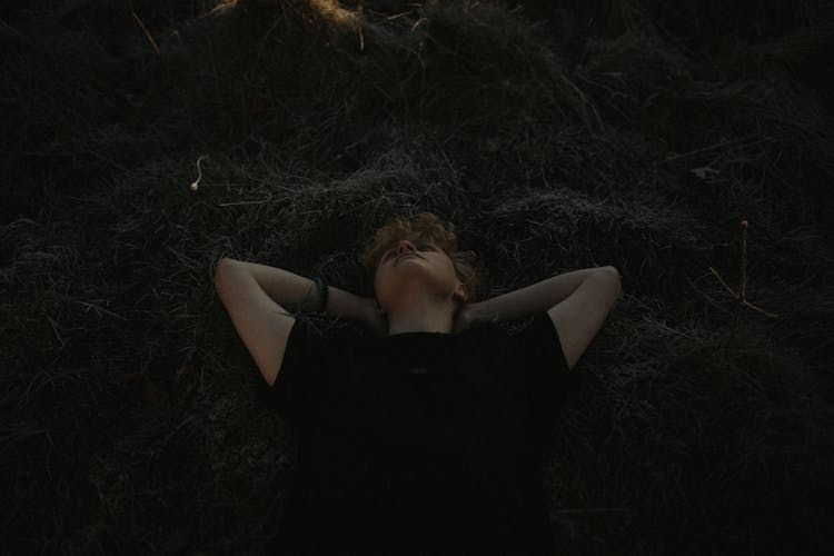 Photograph Of A Man Lying On The Grass