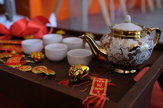 Beautiful Chinese tea ceremony setup featuring ornate porcelain teapot and cups.