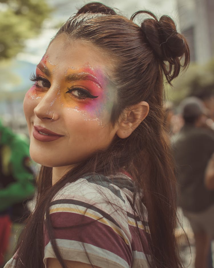 A Woman In Striped Shirt With Makeup On Her Face