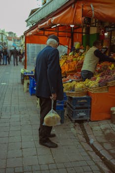 Elderly man shopping for fresh produce at a vibrant Istanbul street market.
