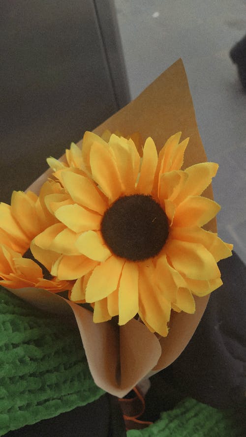 A Plastic Sunflower Wrapped with Parchment Paper