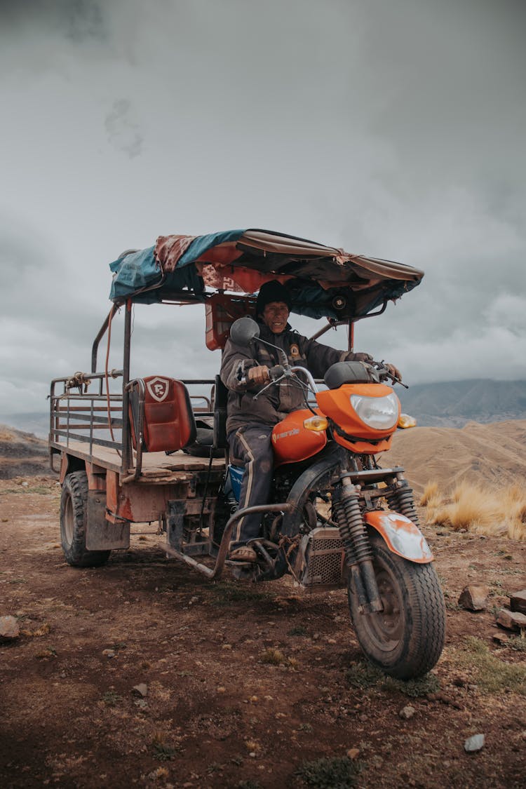 Man Riding A Motorcycle With A Trailer In Mountains 